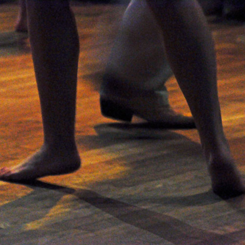 Conscious dance; people's feet on a dance floor